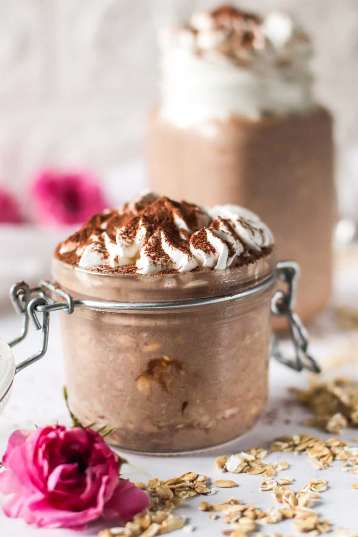 Overnight oats in a jar with whipped cream on top.