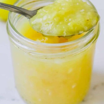 Sauce in a jar with a spoon resting on top.