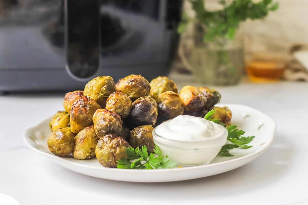 Brussels sprouts on a white plate.