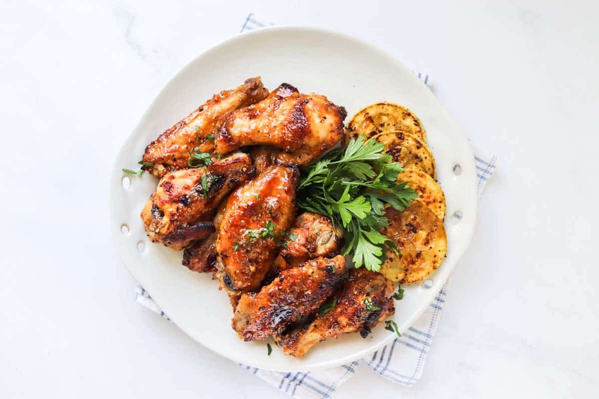 Chicken wings on a white plate.