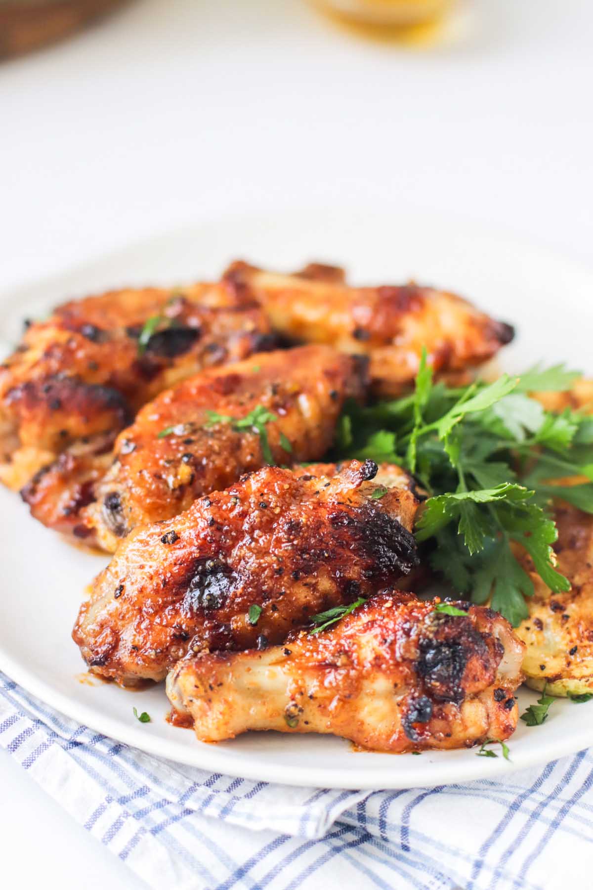 Saucy wings on a white plate.