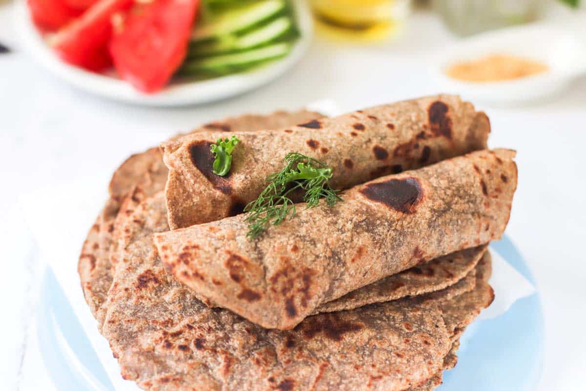 Two rolled tortillas on a plate.