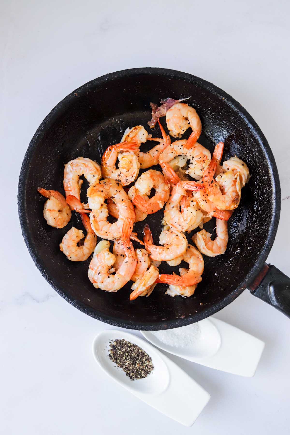 Shrimp cooked in a cast iron pan.