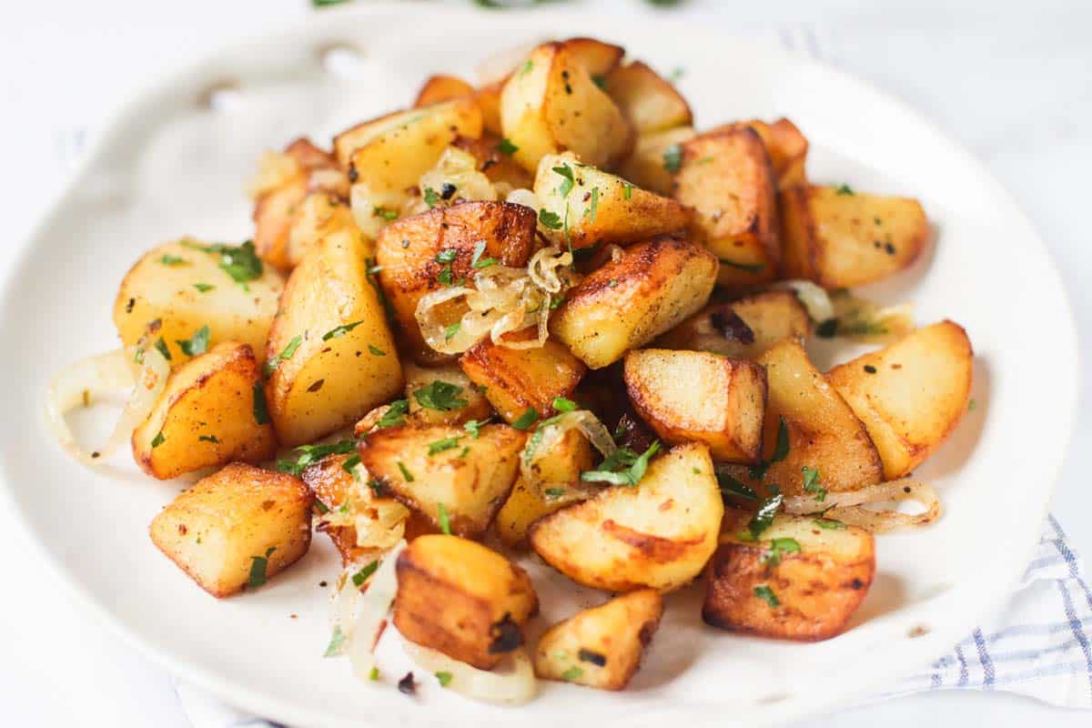 Fried potatoes on a white plate.