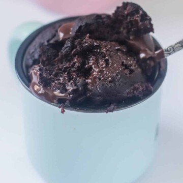 Cake in a mug scooped on a spoon.