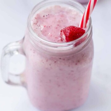 Milkshake in a jar with a straw.