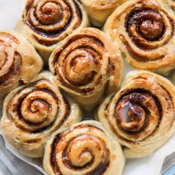 Baked cinnamon rolls in a baking dish.