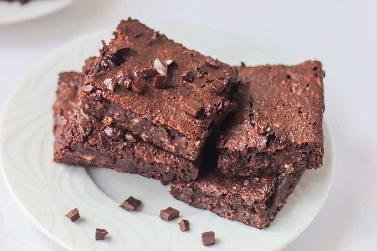 Brownies stacked on a plate.