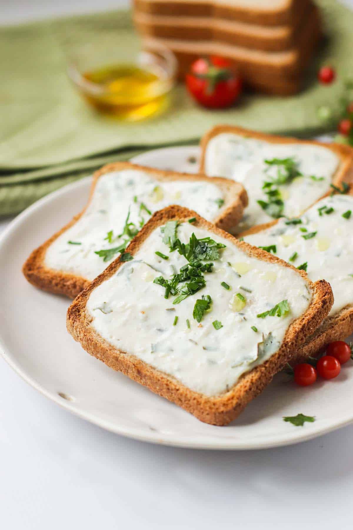 Garlic bread stacked on a white plate.