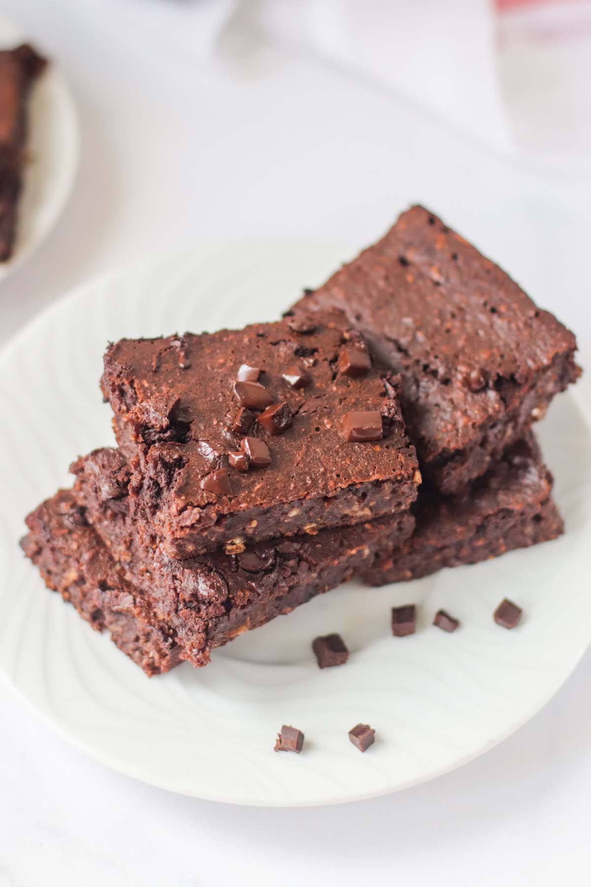 Brownie squares on a white plate.