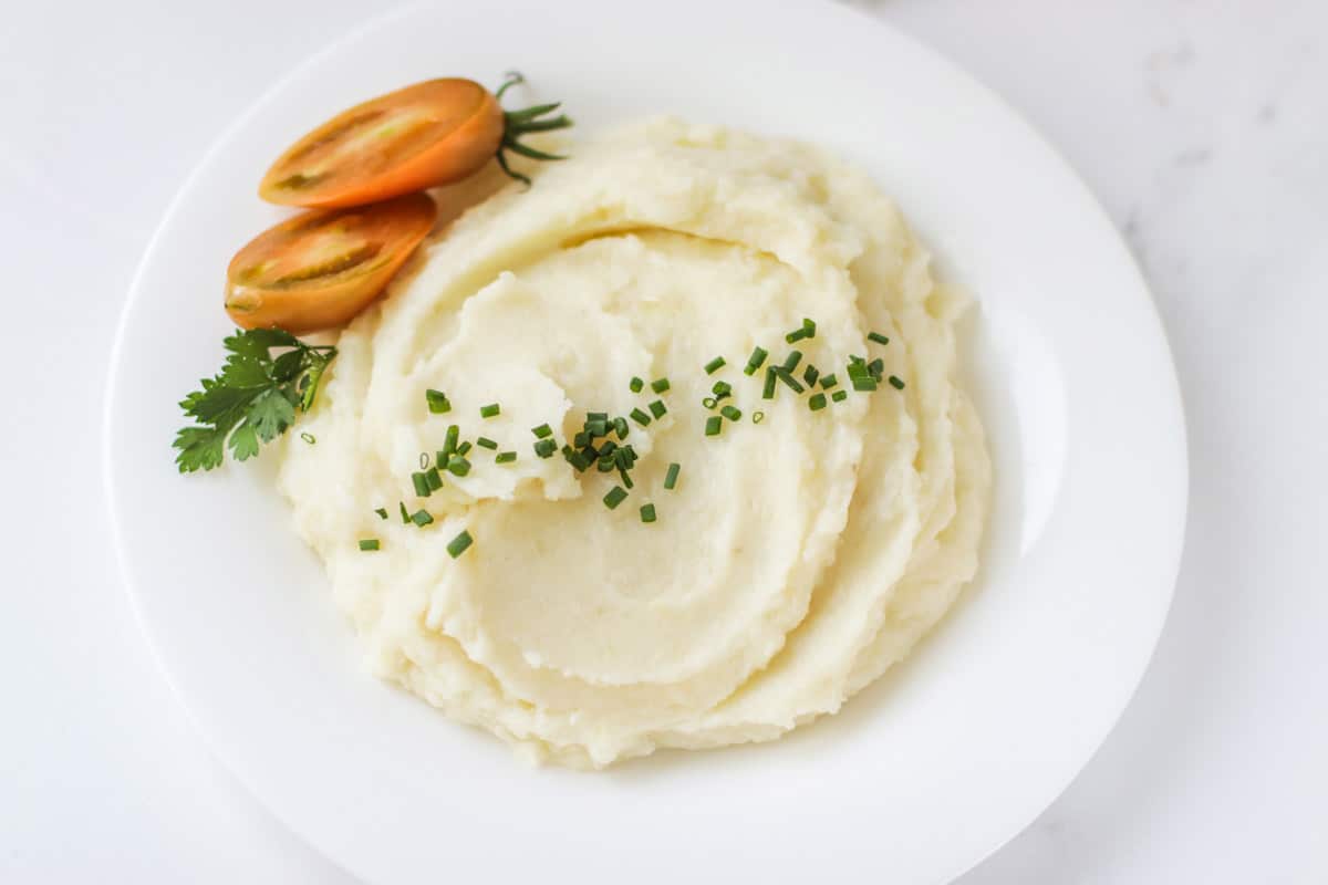 Mashed potatoes on a white plate.