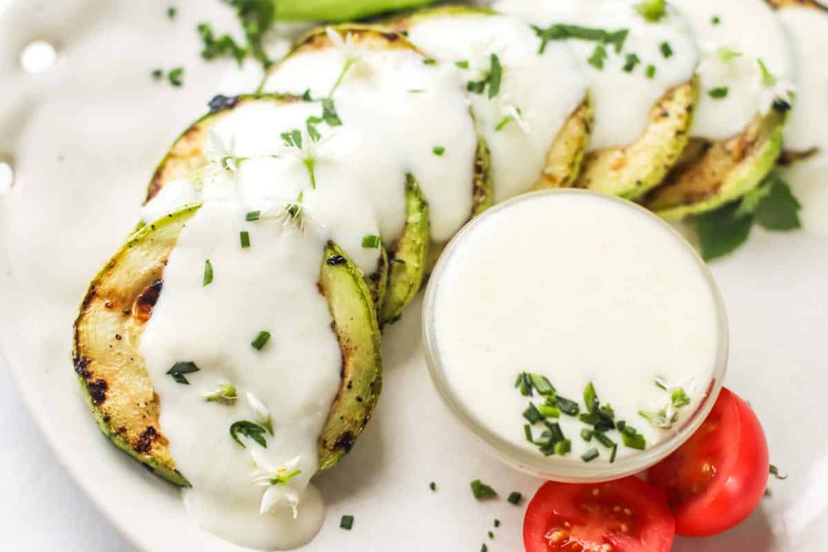 Cheese sauce poured over grilled zucchini.