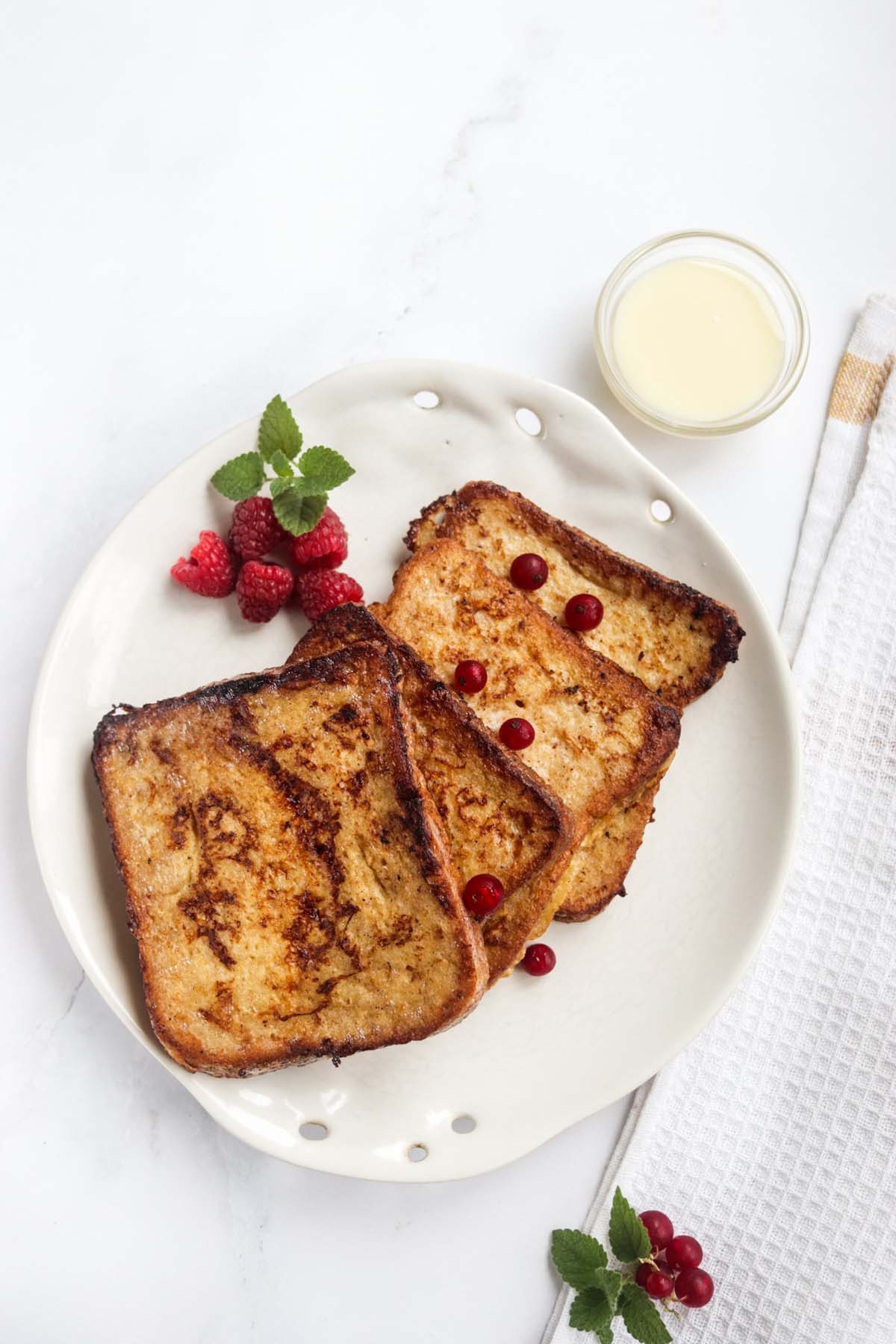 French toast on a plate with berries.