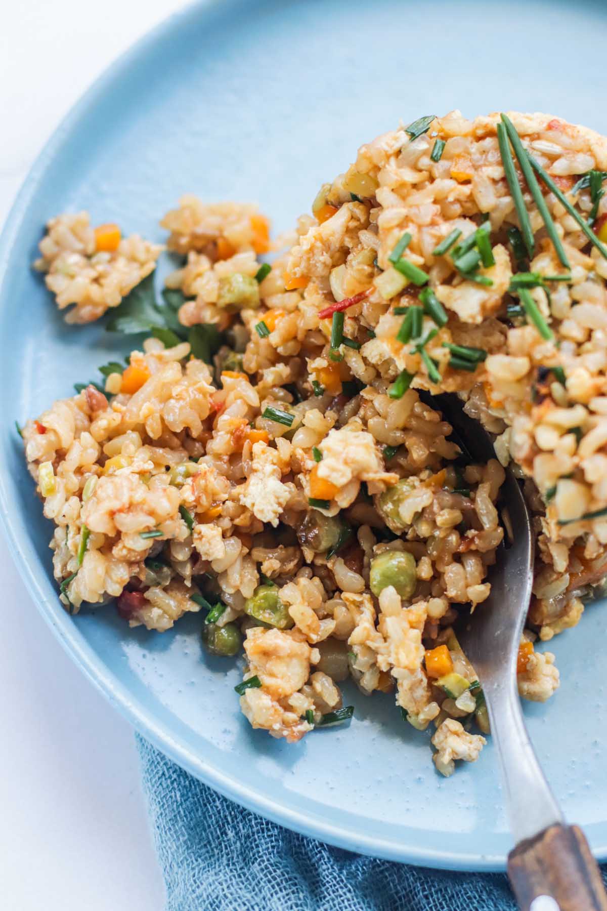 Fried rice scooped on a fork.