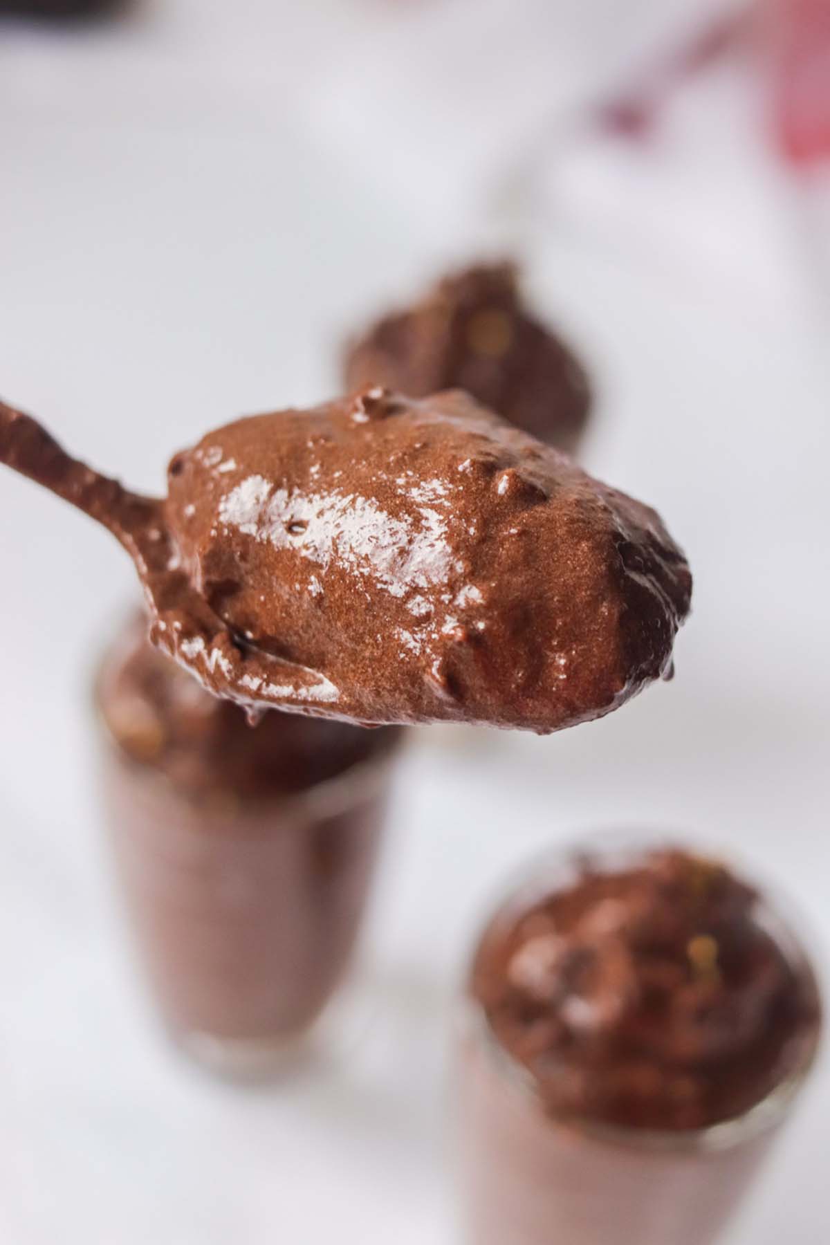 Chocolate mousse scooped on a spoon.