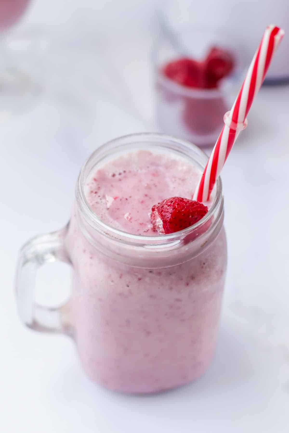 Milkshake in a jar with a straw.