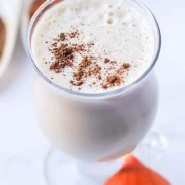 A latte topped with spices.