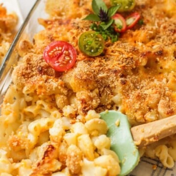 A spatula in the baking dish with the mac and cheese.