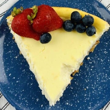A slice of cheesecake on a blue plate.