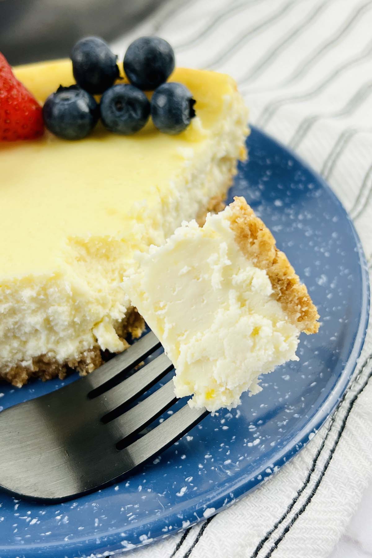 A piece of cheesecake on a fork.