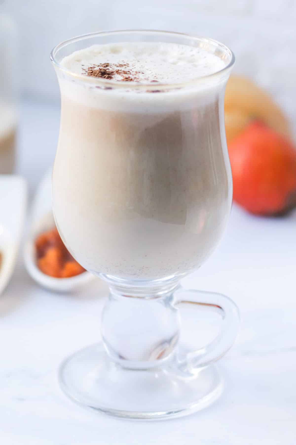 A latte in a glass cup.
