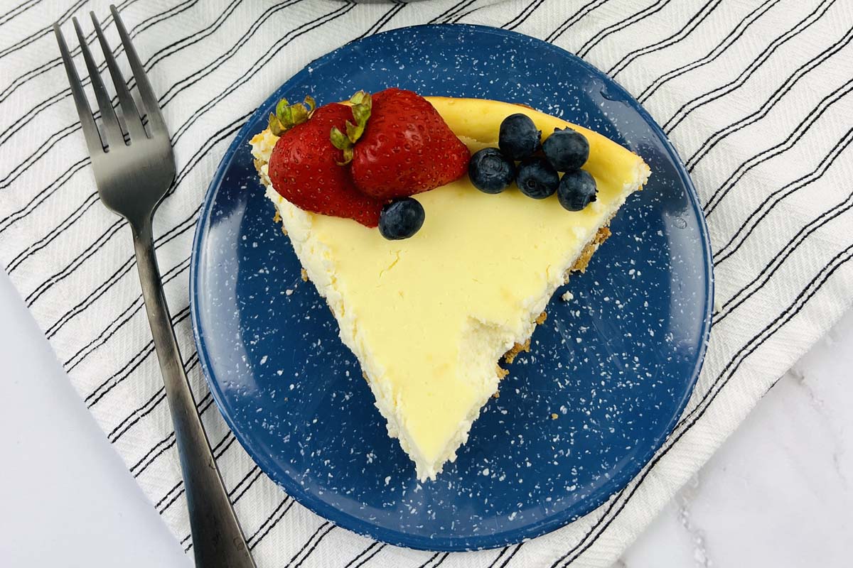 A slice of cheesecake on a blue plate.