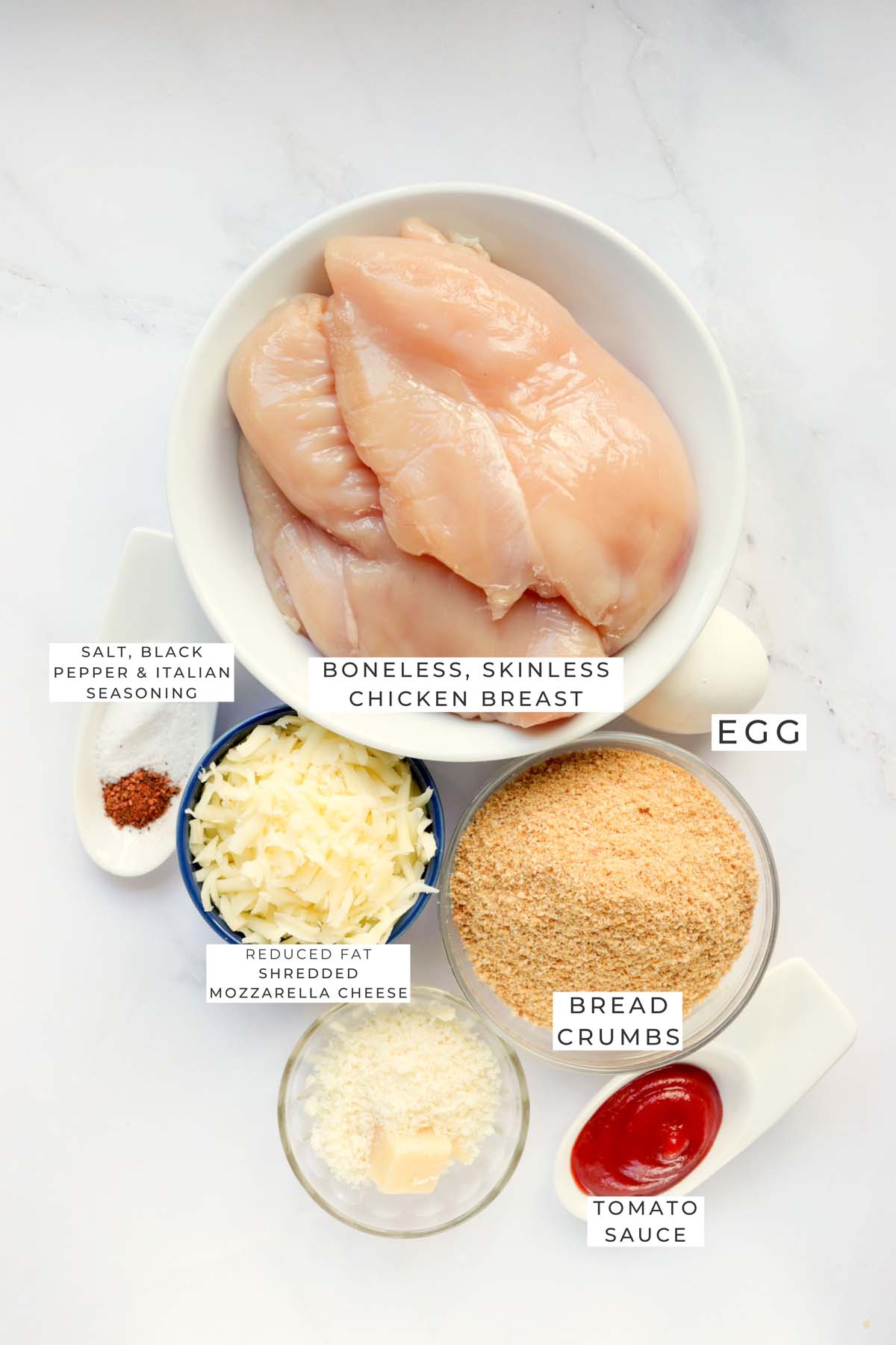 Labeled ingredients to make chicken parmesan.