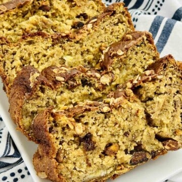 Sliced banana bread on a white plate.