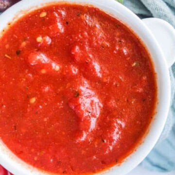 Pizza sauce in a white bowl.