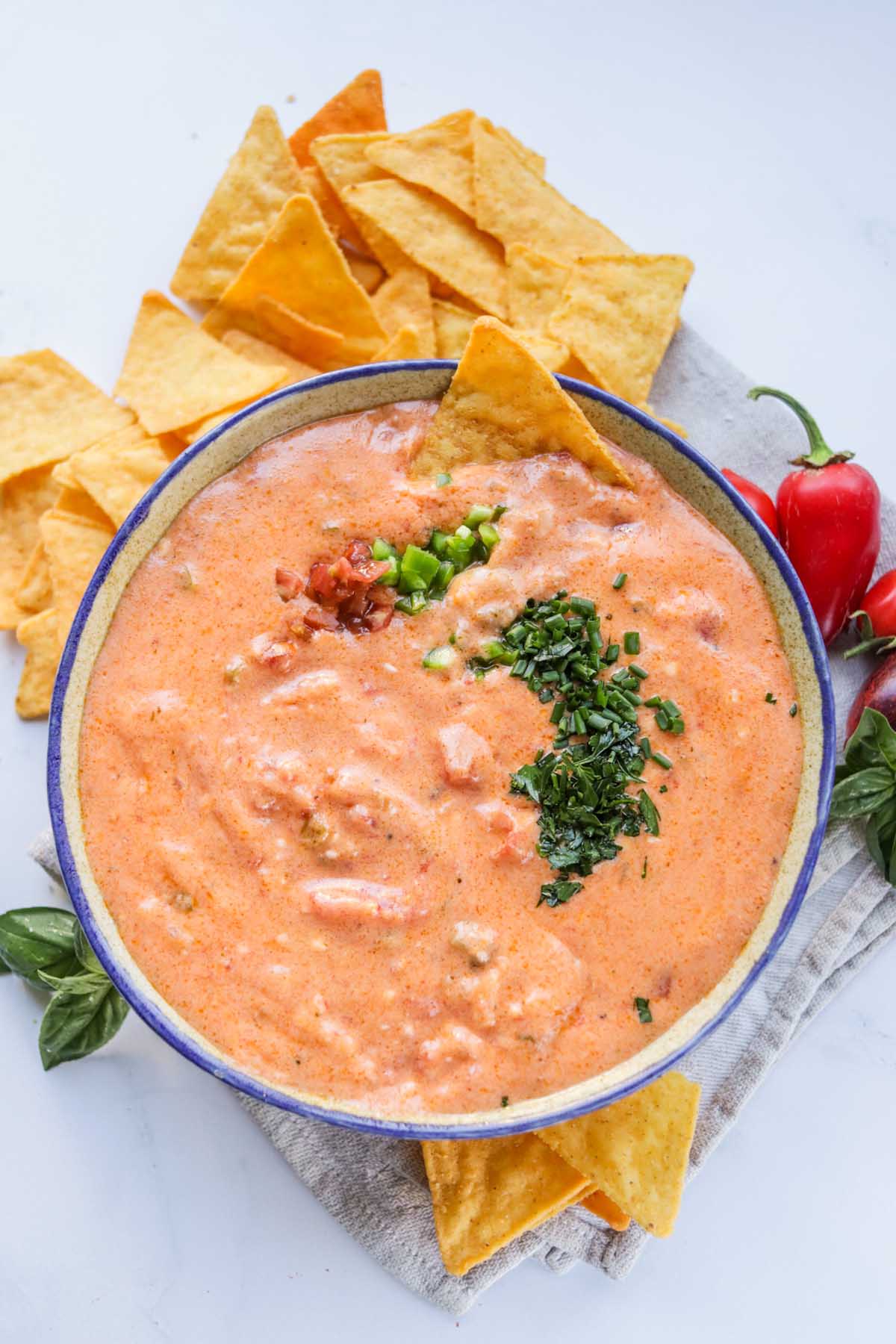 Queso dip in a bowl set on a kitchen towel.