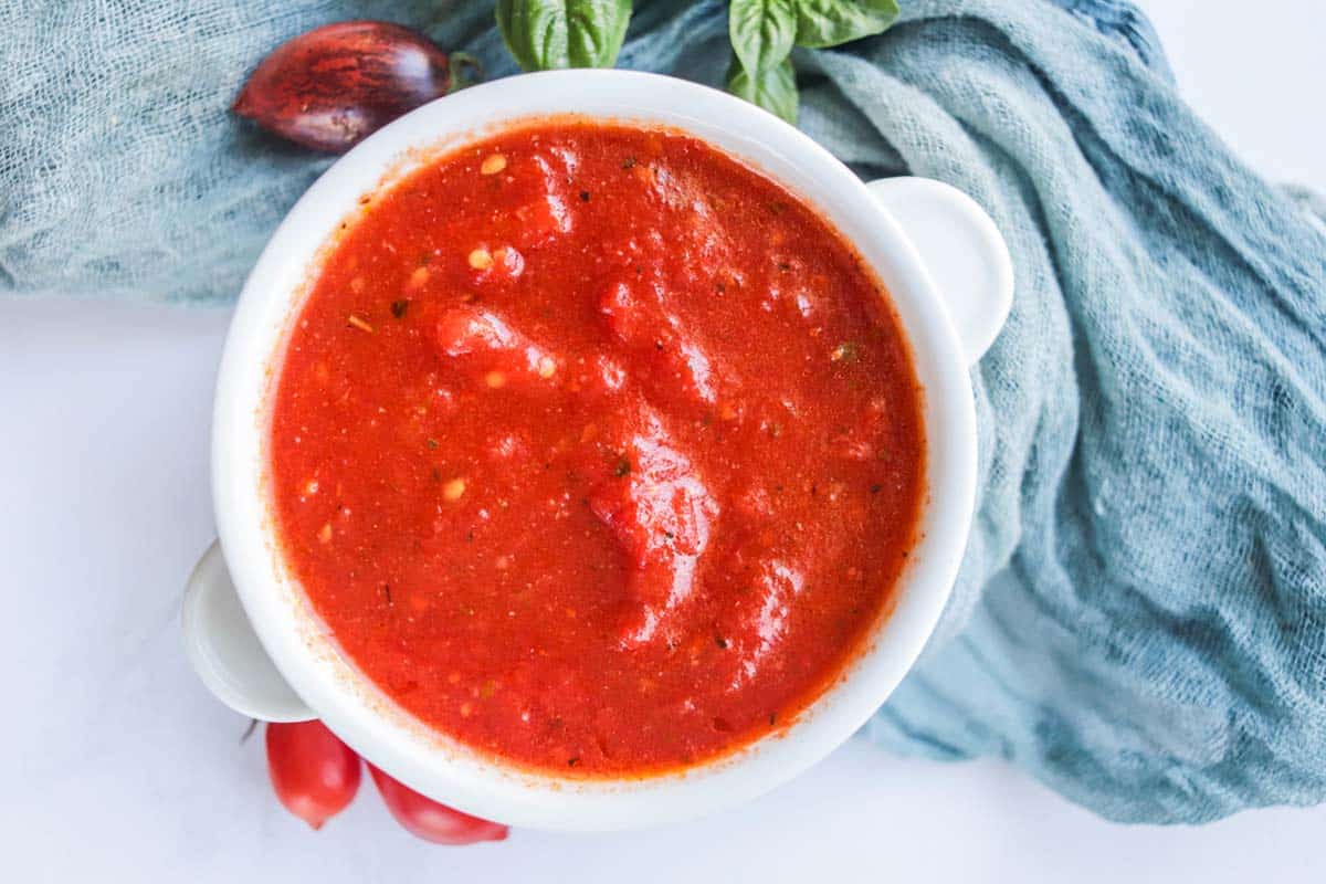 Pizza sauce in a white bowl.