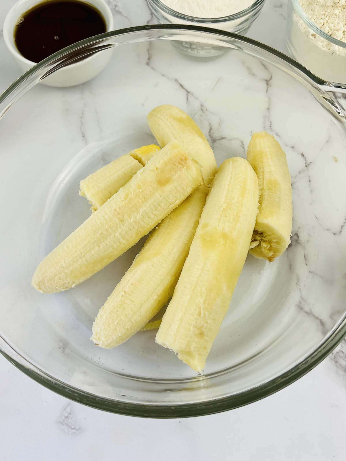Bananas in a glass bowl.