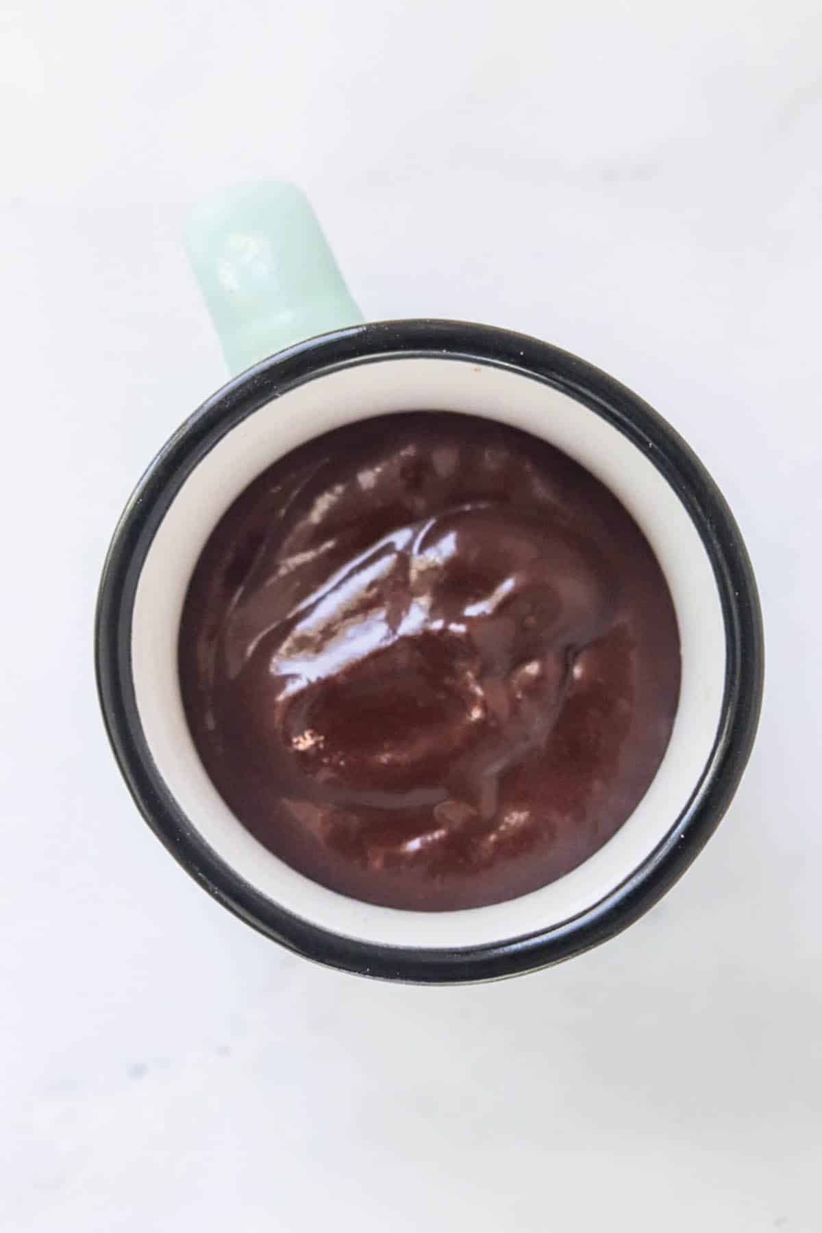 Chocolate cake batter in a mug.