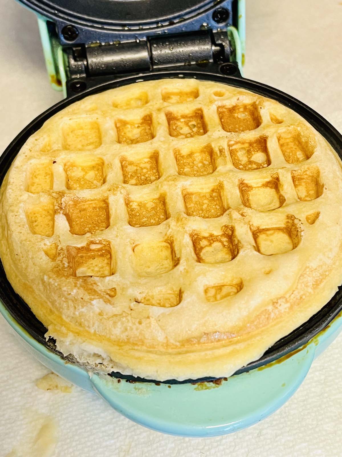 Cooked waffle in a waffle maker.