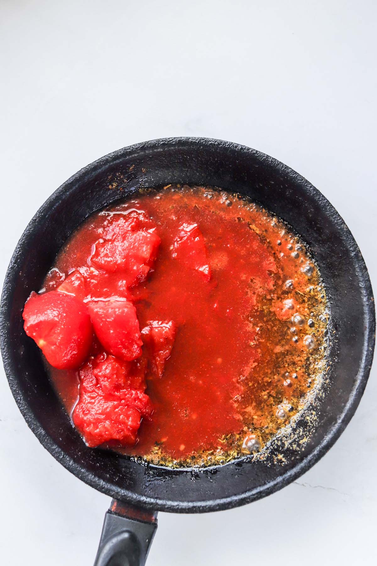 Tomato chunks in a skillet.