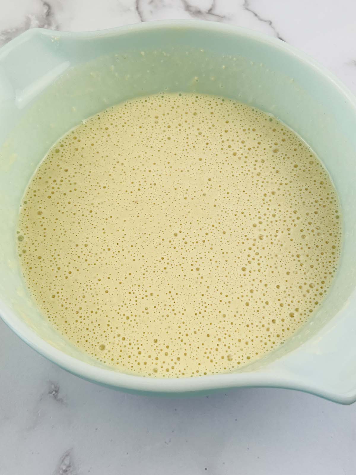 Waffle batter in a mixing bowl.