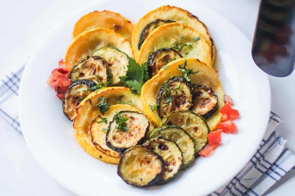 Sliced squash lined up on a plate.