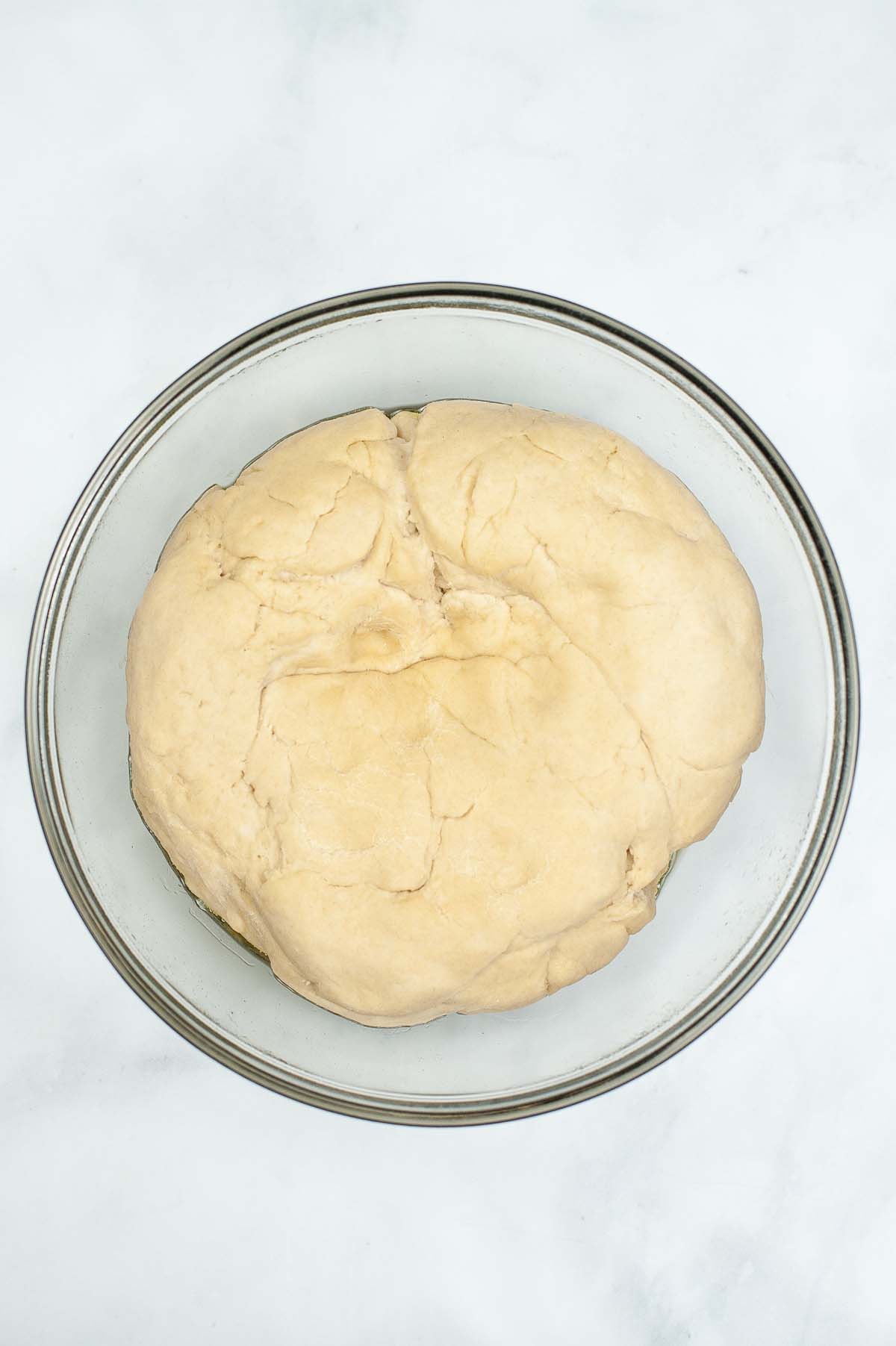 A dough ball in a mixing bowl.