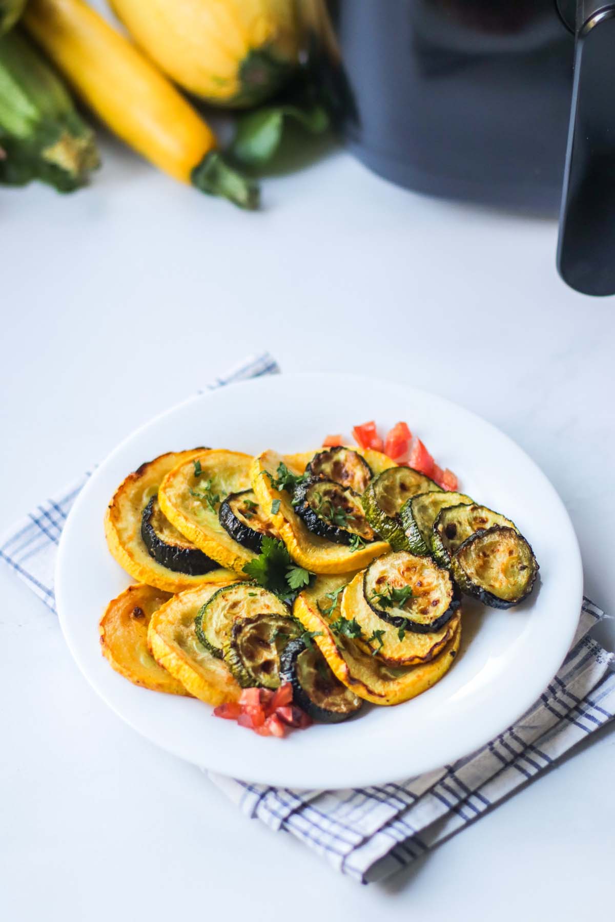 Squash on a plate that is set on a kitchen towel.