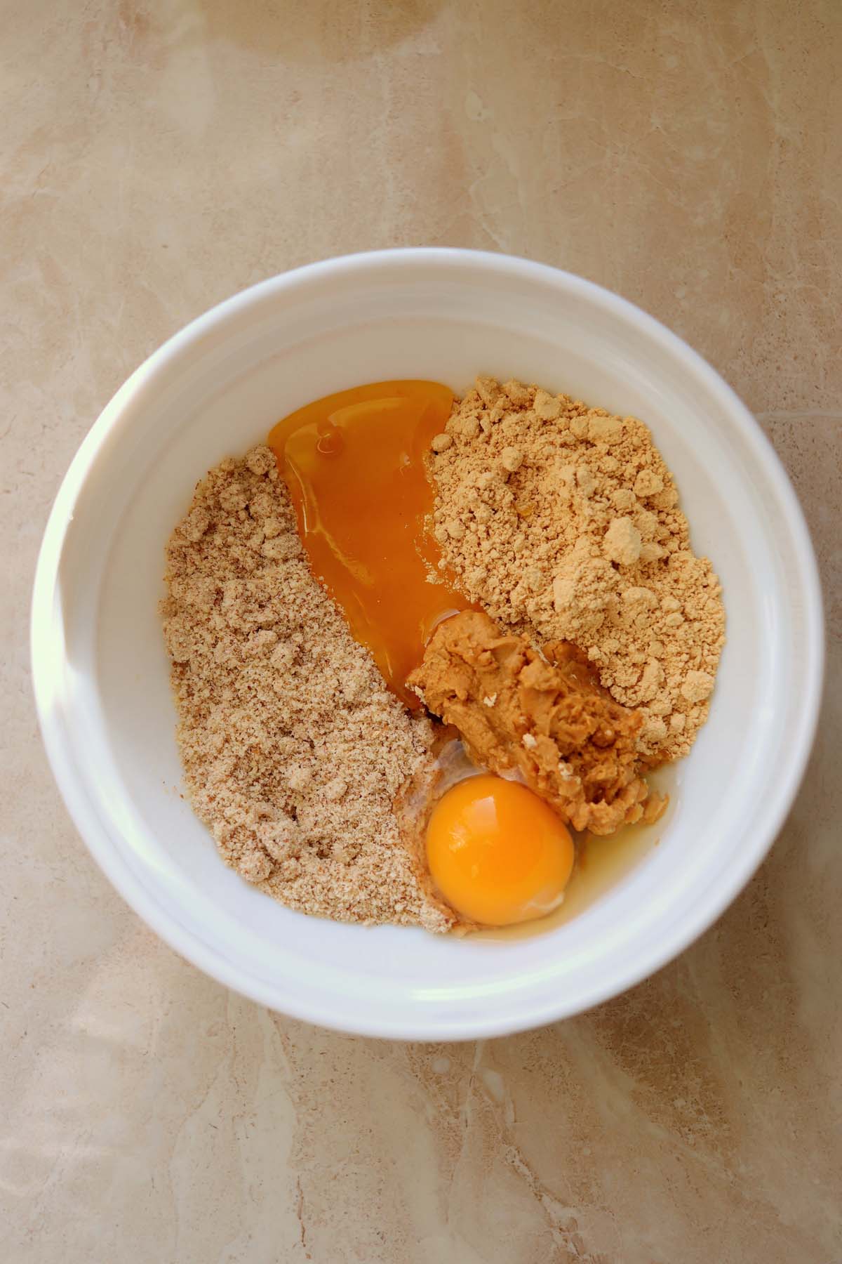 Egg and honey added to the peanut butter powder.