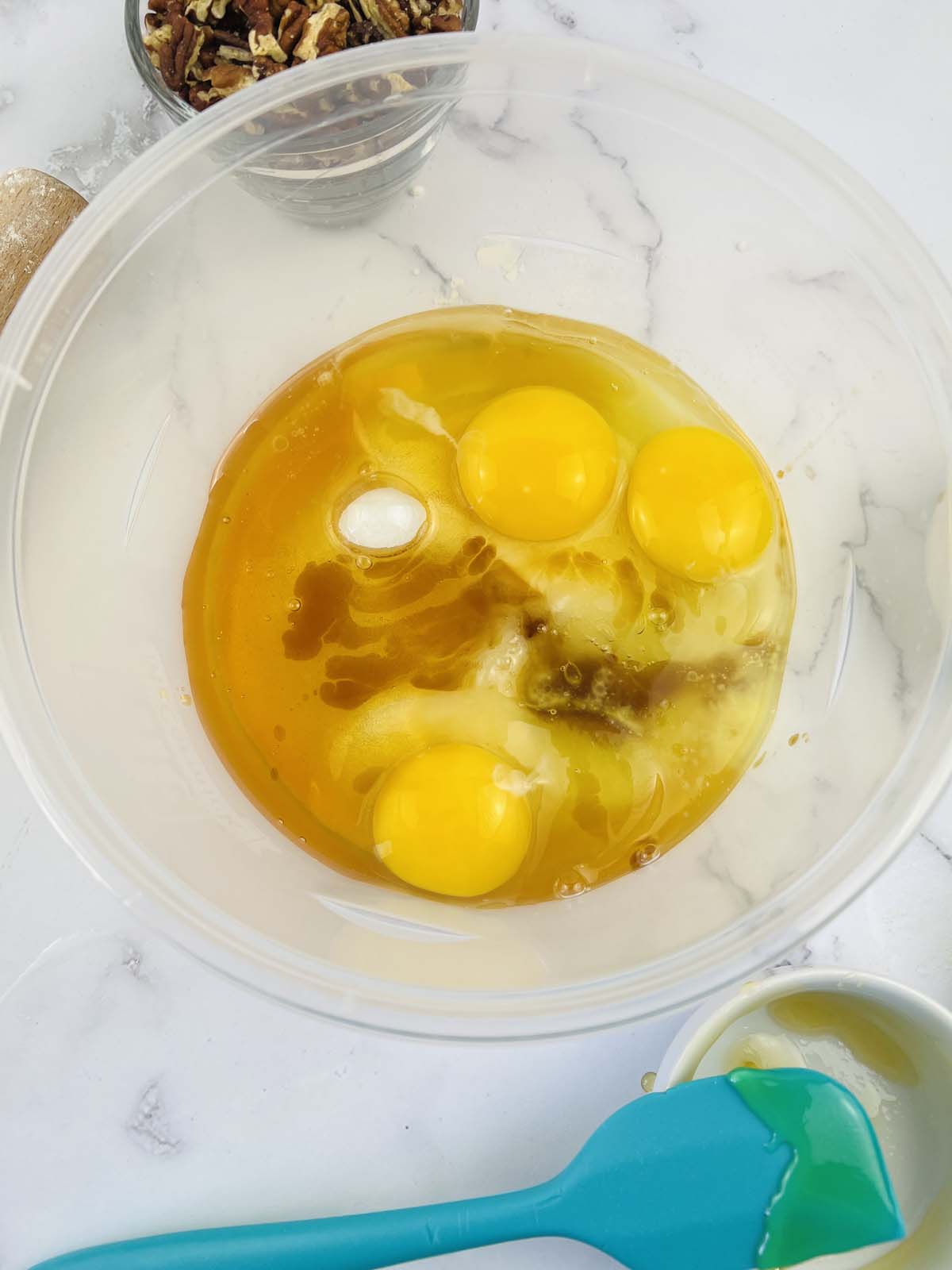 Eggs and vanilla in a mixing bowl.