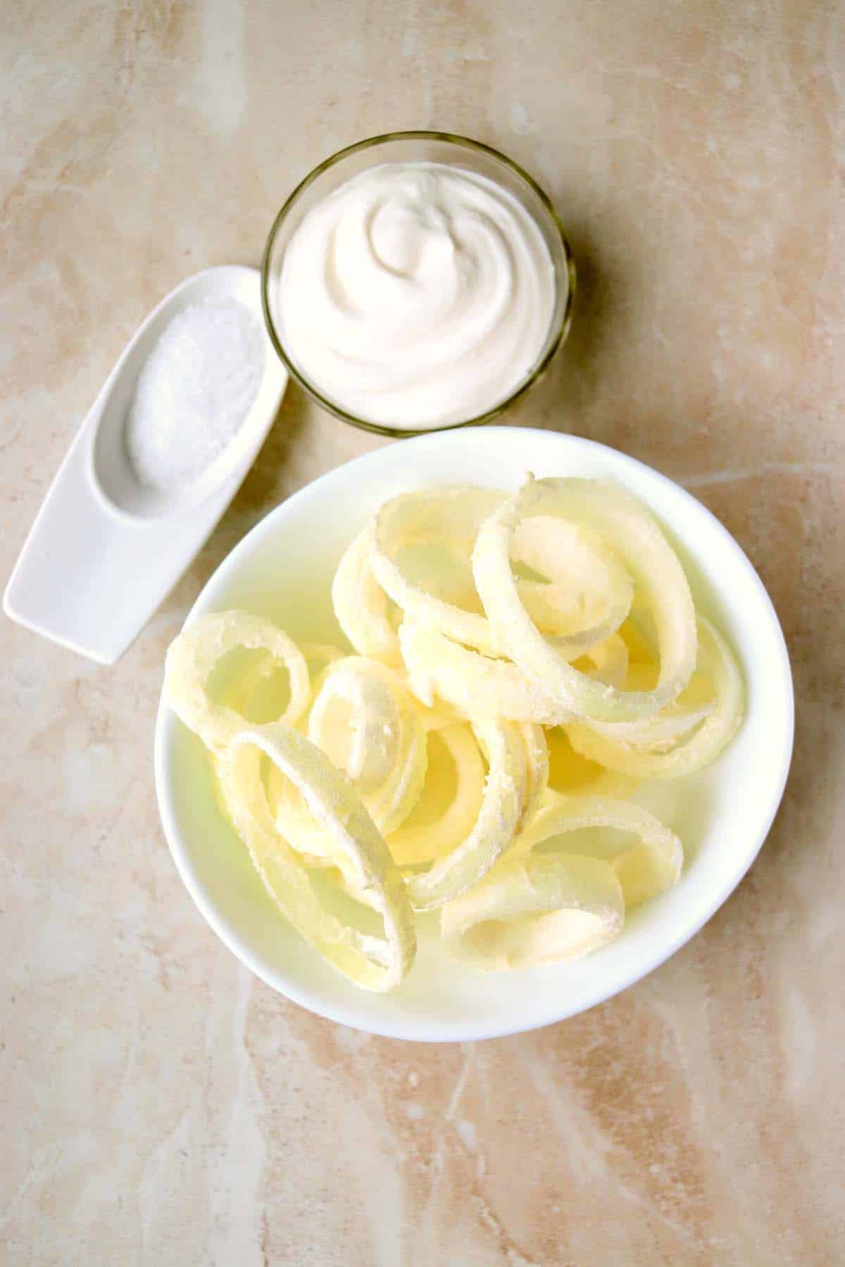 Sliced onions coated in flour.