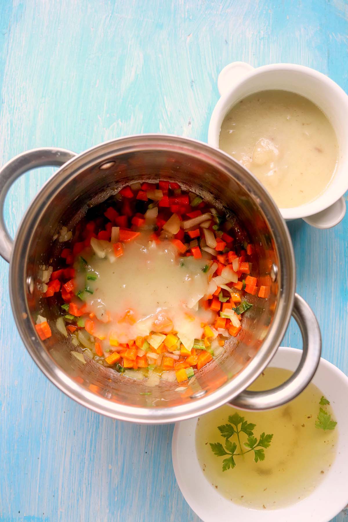 The mirepoix in the pot with the condensed soup on top.