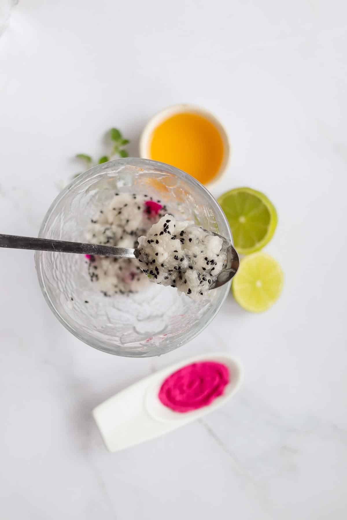 Muddled dragon fruit on a spoon.