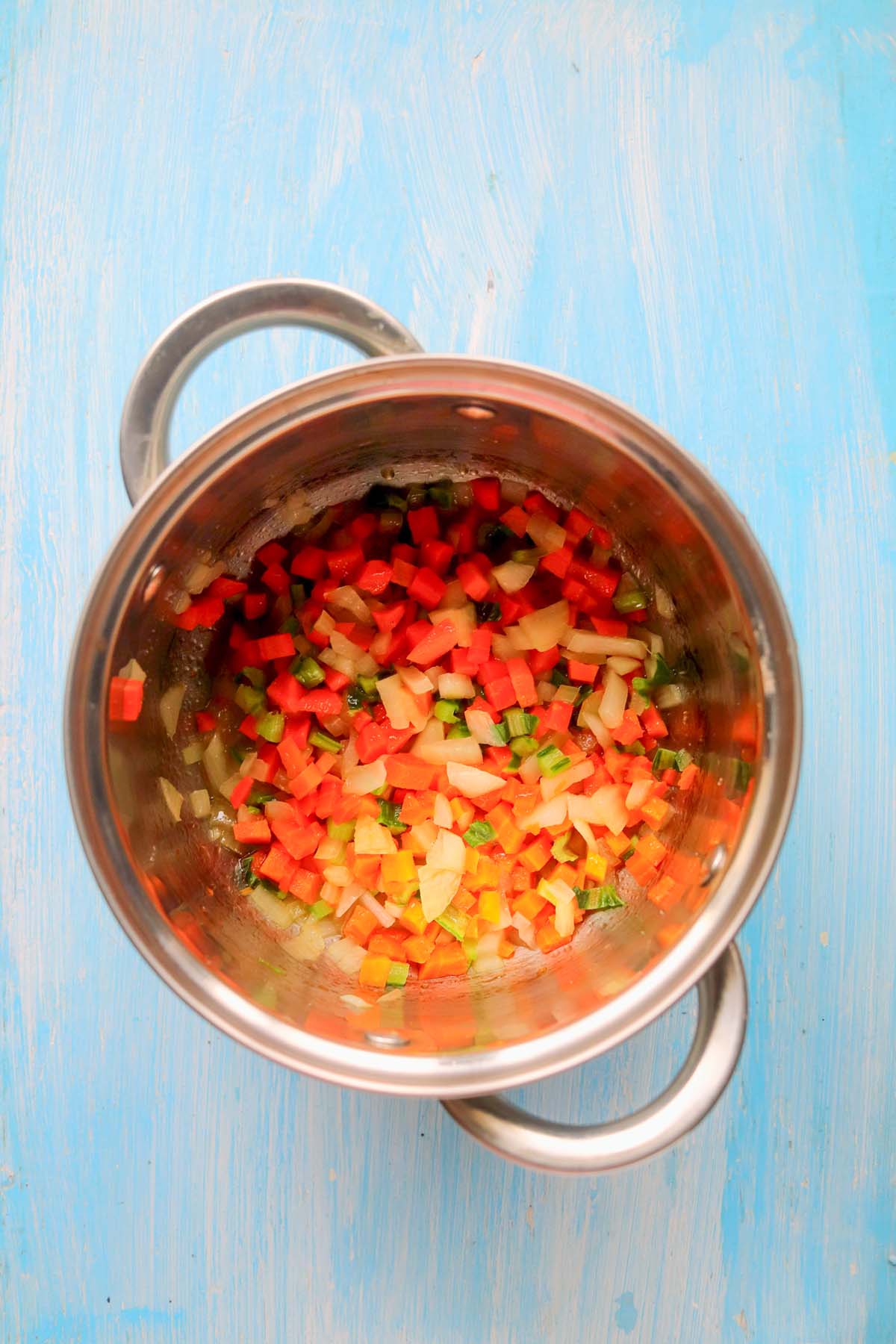 The mirepoix in a pot with olive oil.