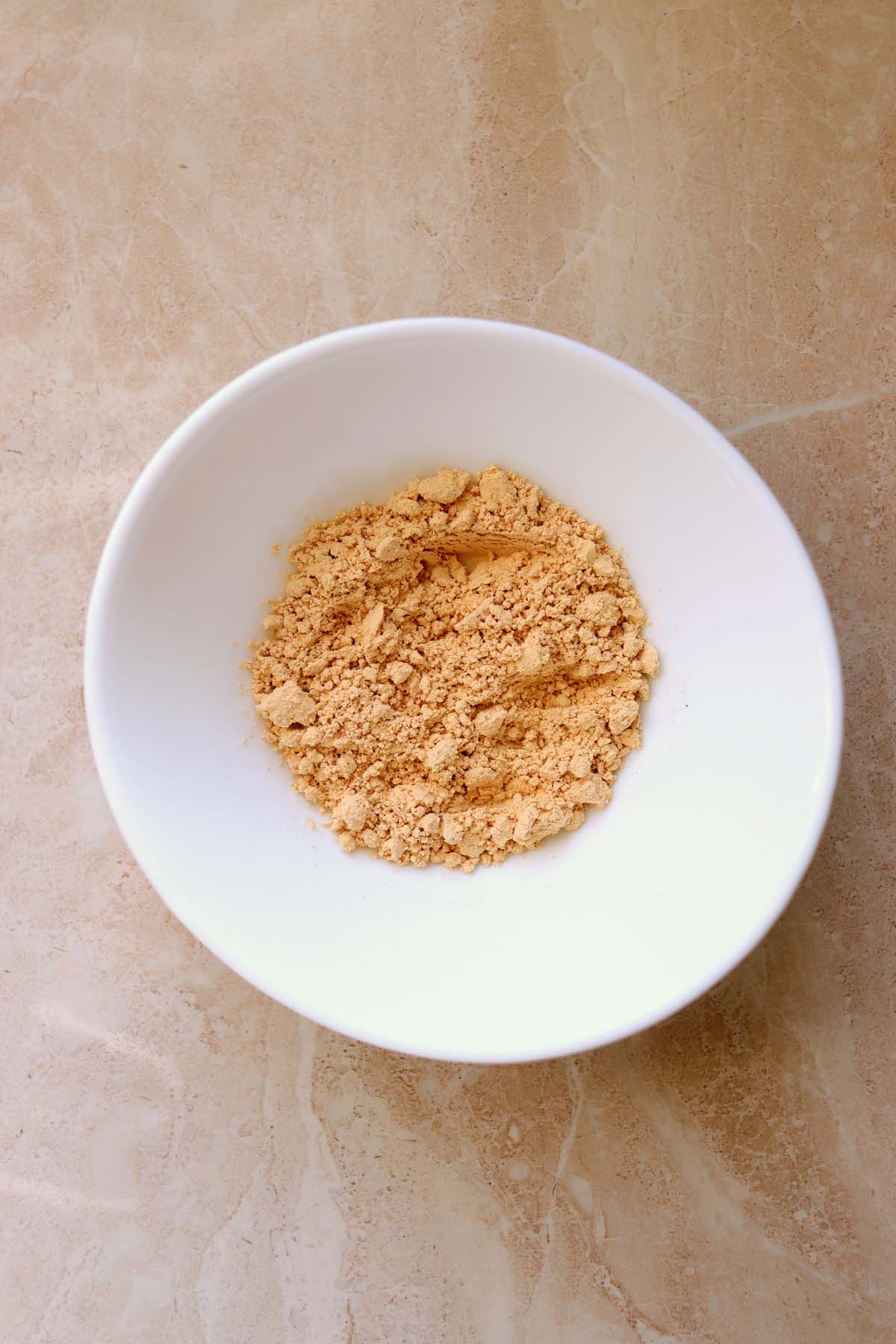 Peanut butter powder and water in a bowl.