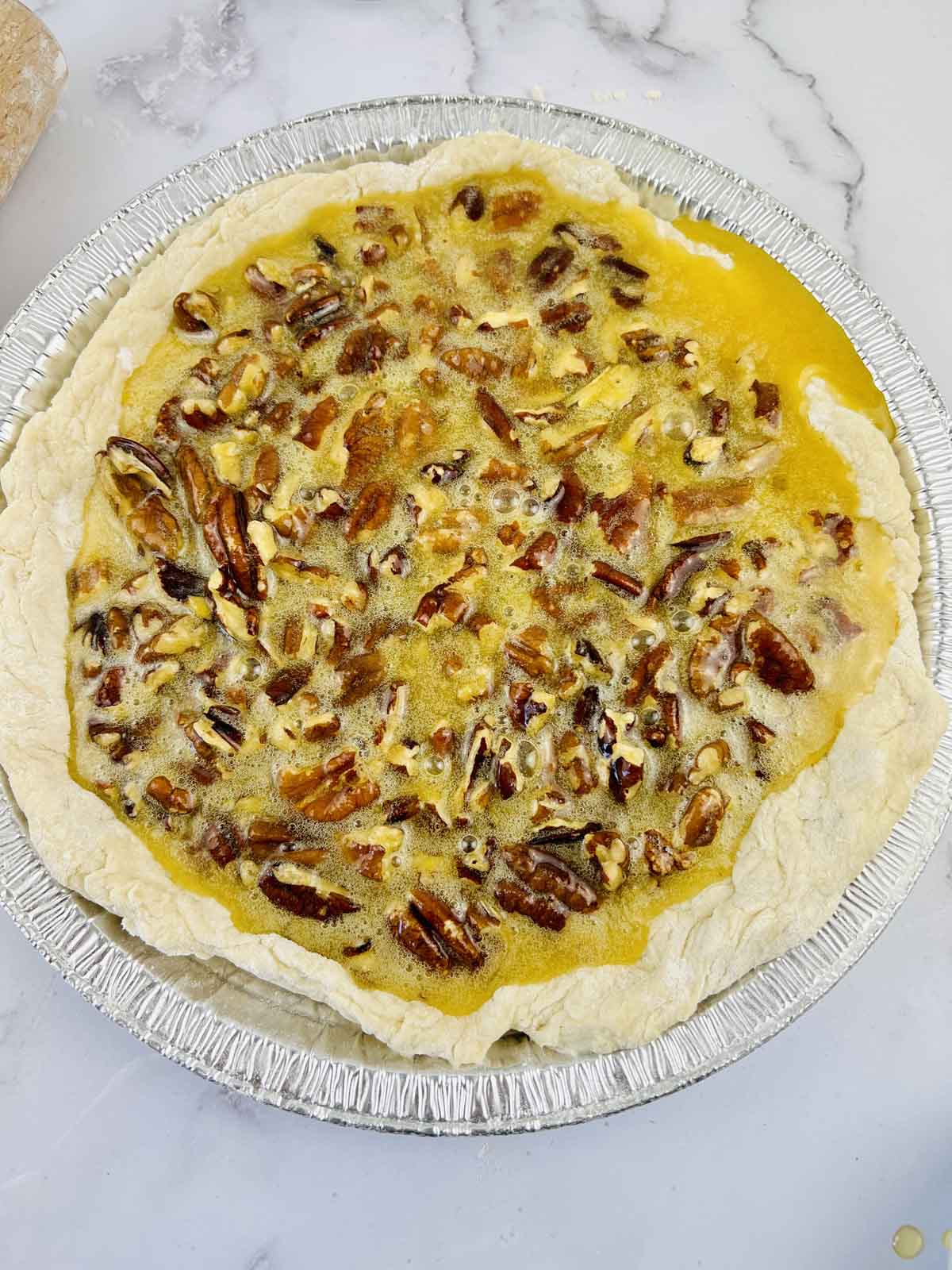 The pecan filling inside the pie dough.