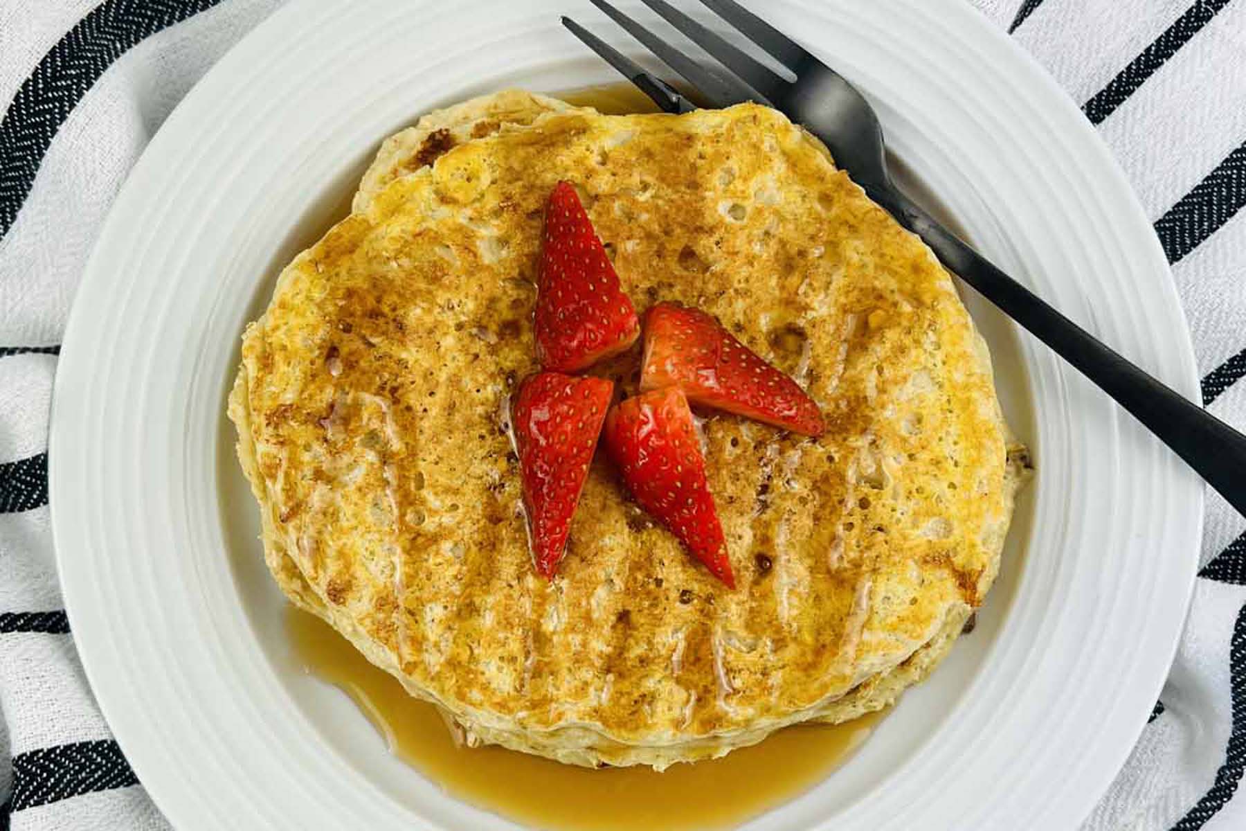 Pancakes on a plate with a fork.