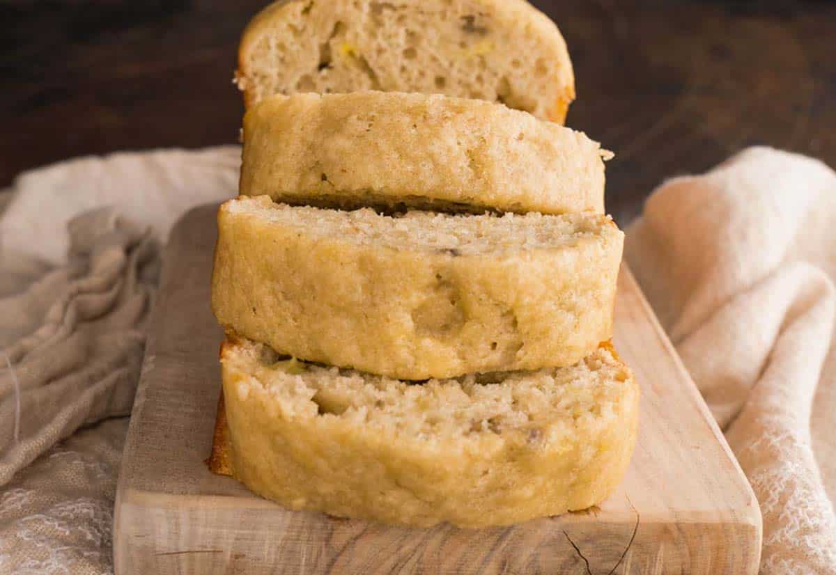 Sliced banana bread on a cutting board.