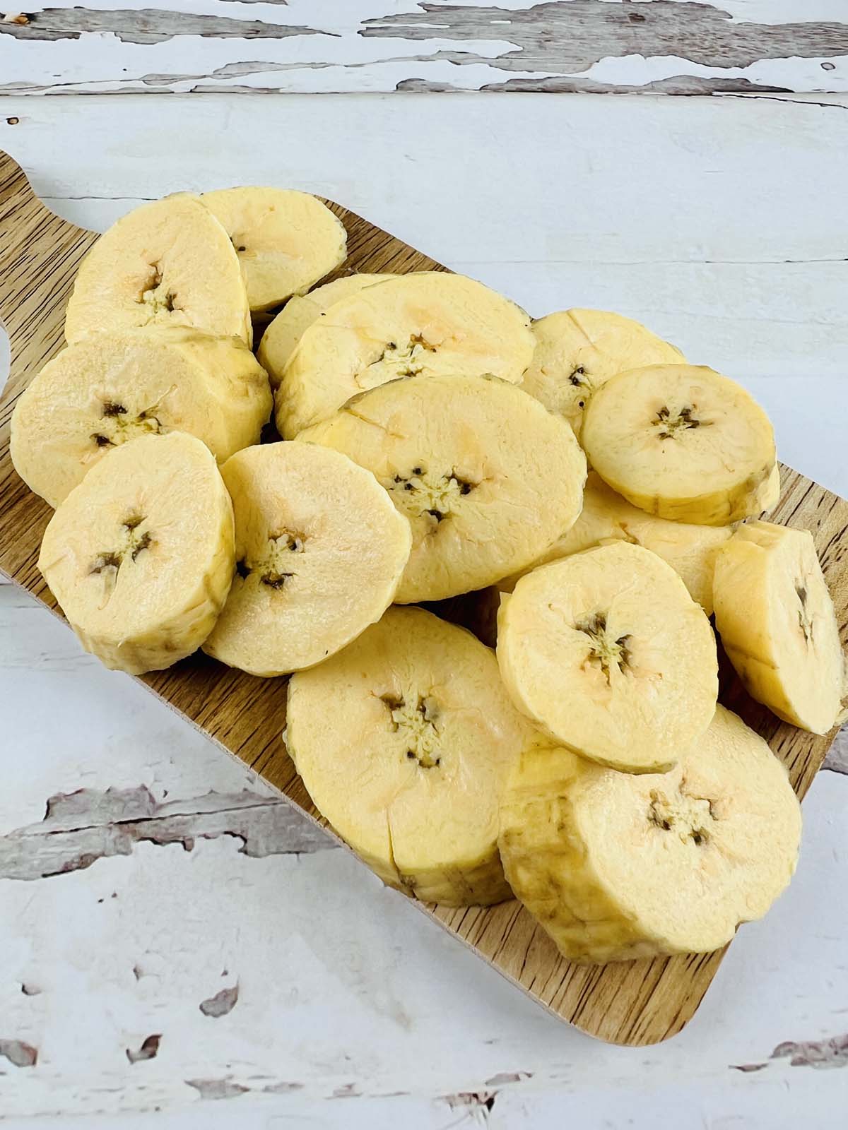 Plantain slices on a cutting board.